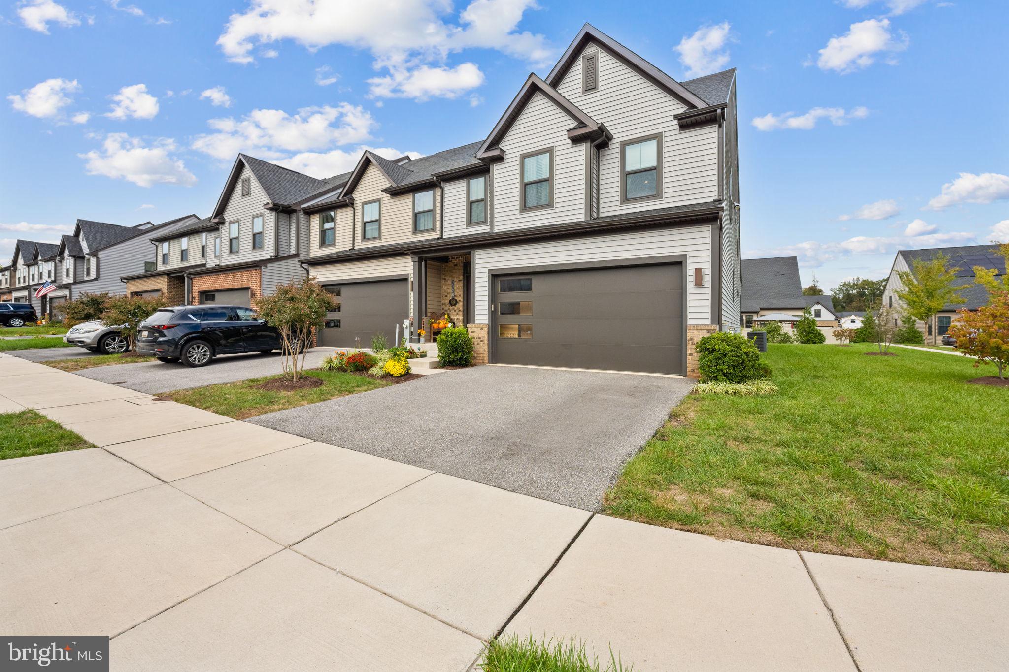 7728 Pestle Lane Glen Burnie, MD 21060 - Photo 5 of 66 a front view of a house with a yard and garage