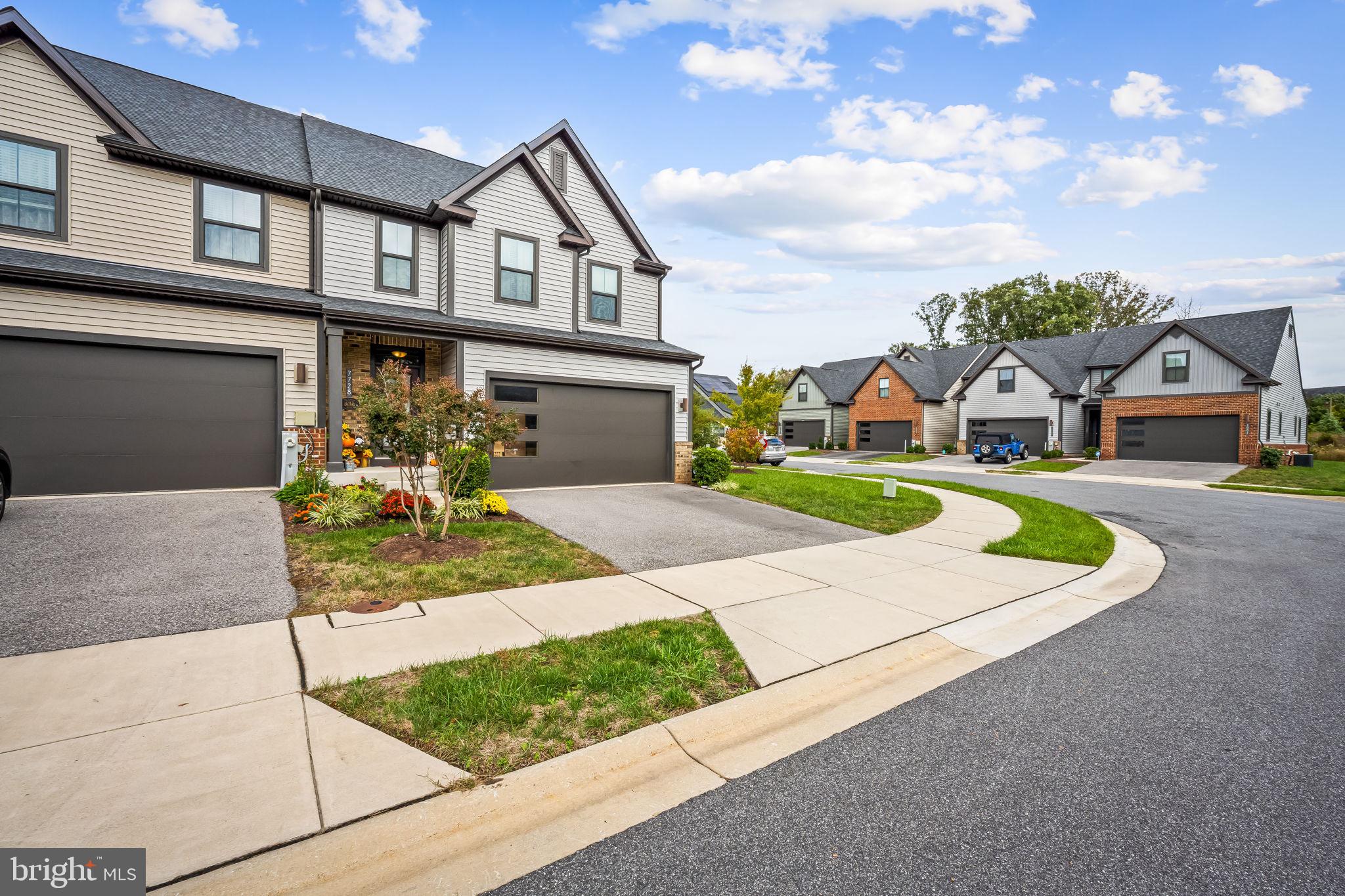 7728 Pestle Lane Glen Burnie, MD 21060 - Photo 6 of 66 a front view of a house with a yard and garage