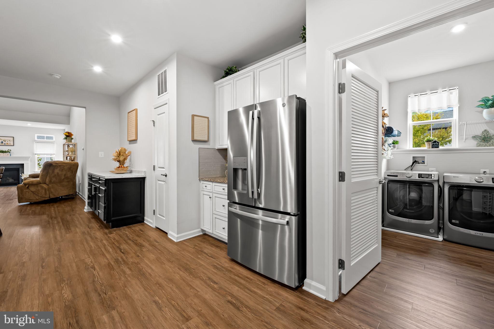 7728 Pestle Lane Glen Burnie, MD 21060 - Photo 10 of 66 a kitchen with stainless steel appliances a refrigerator and a wooden floor