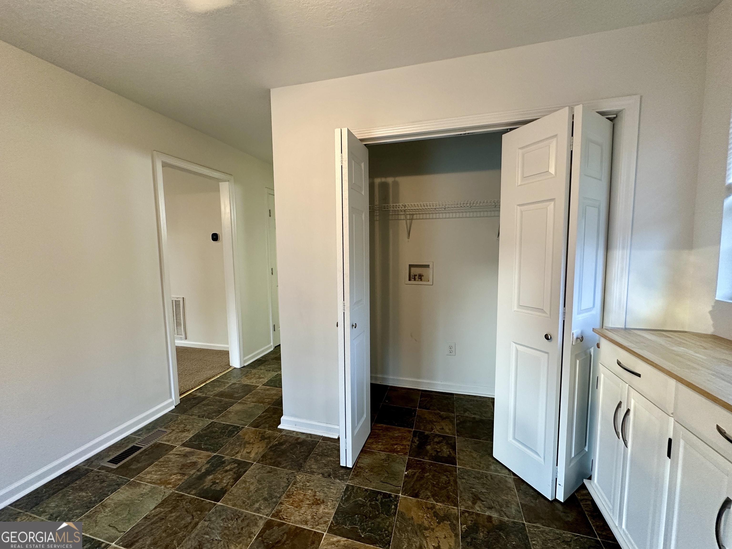 122 Forest Avenue Commerce, GA 30529 - Photo 13 of 17 a view of a hallway with wooden floor and a bathroom