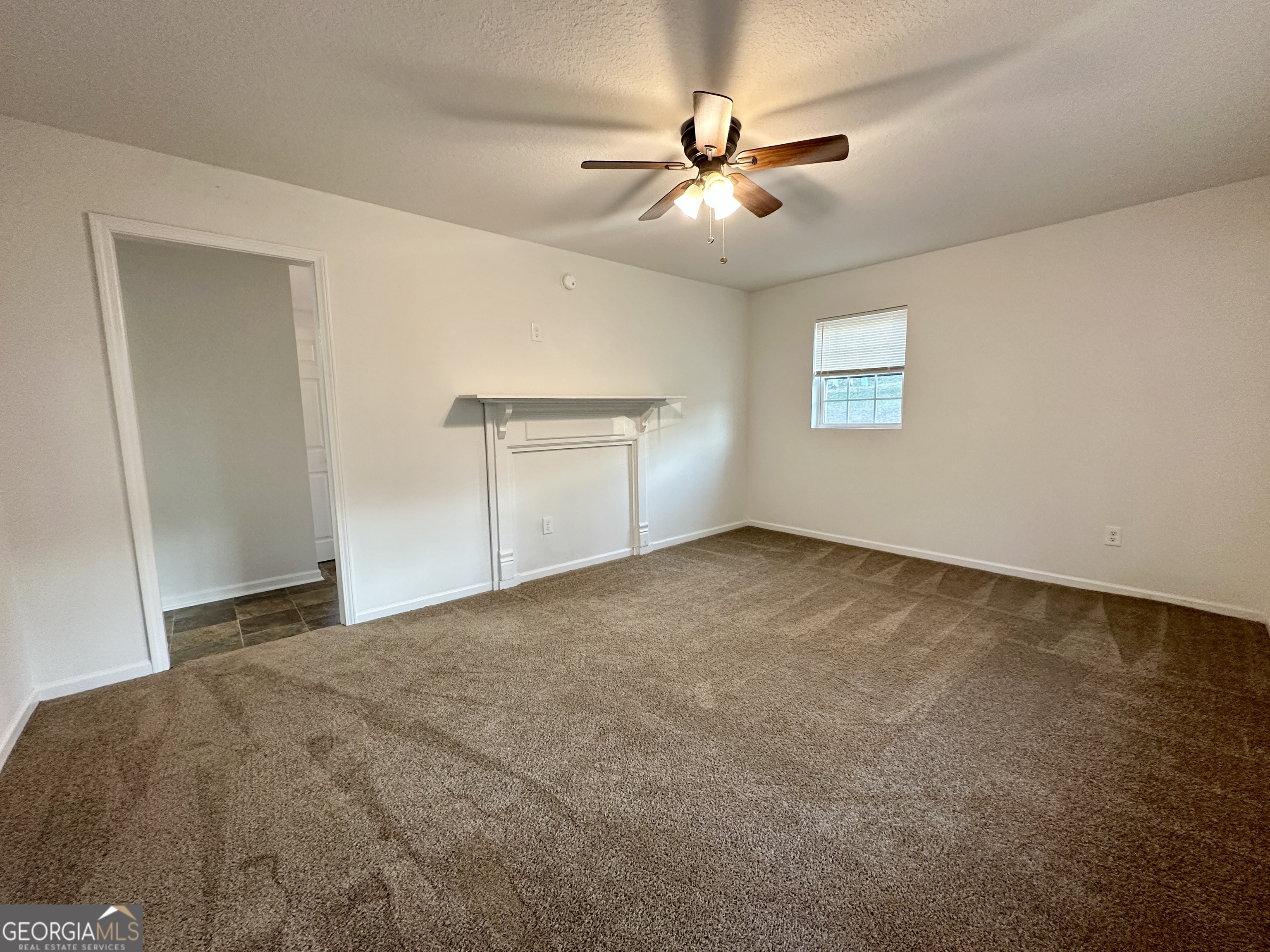 122 Forest Avenue Commerce, GA 30529 - Photo 2 of 17 a view of a livingroom with a ceiling fan and window