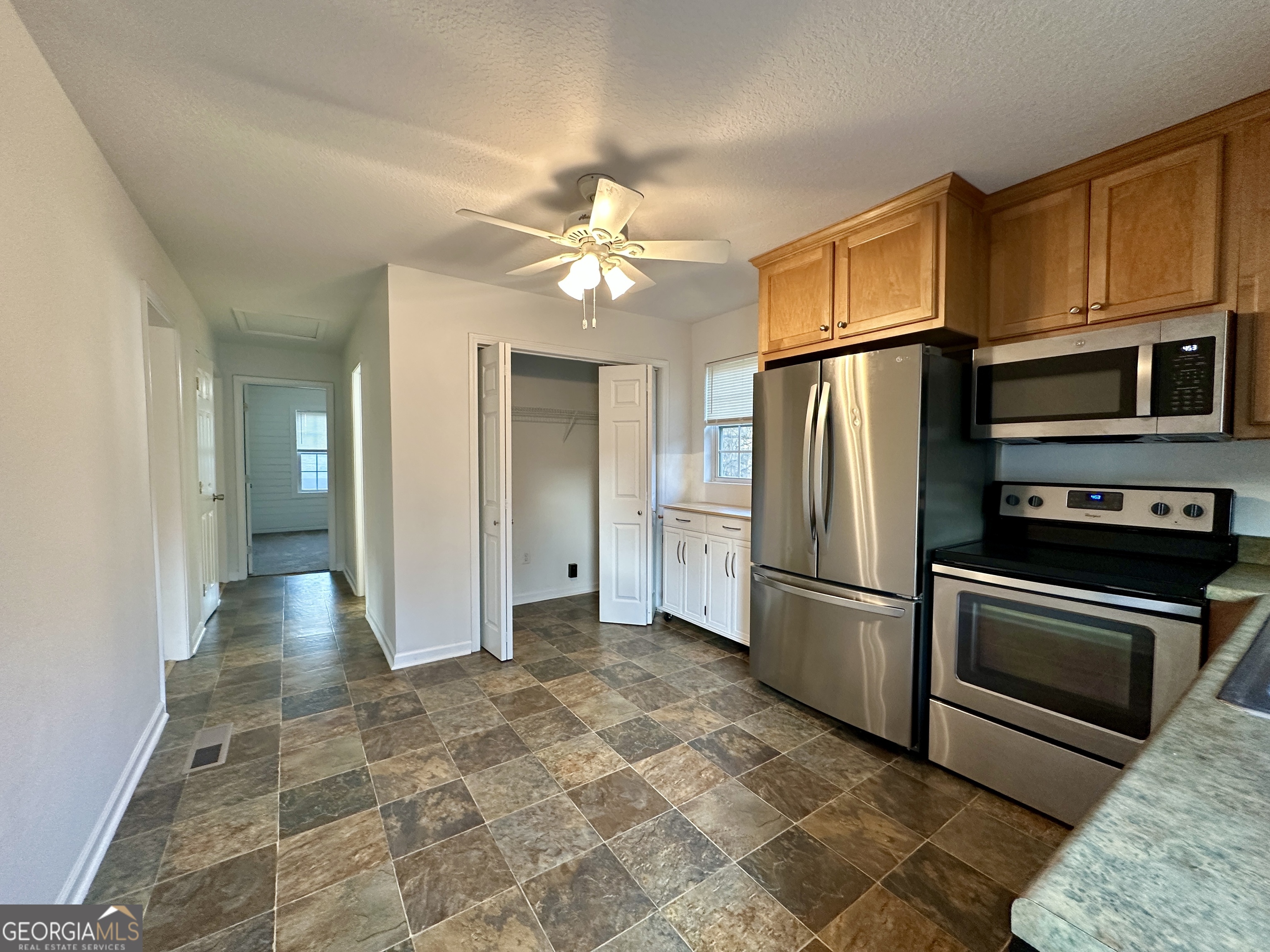 122 Forest Avenue Commerce, GA 30529 - Photo 6 of 17 a view of a kitchen with a stove cabinets and a kitchen
