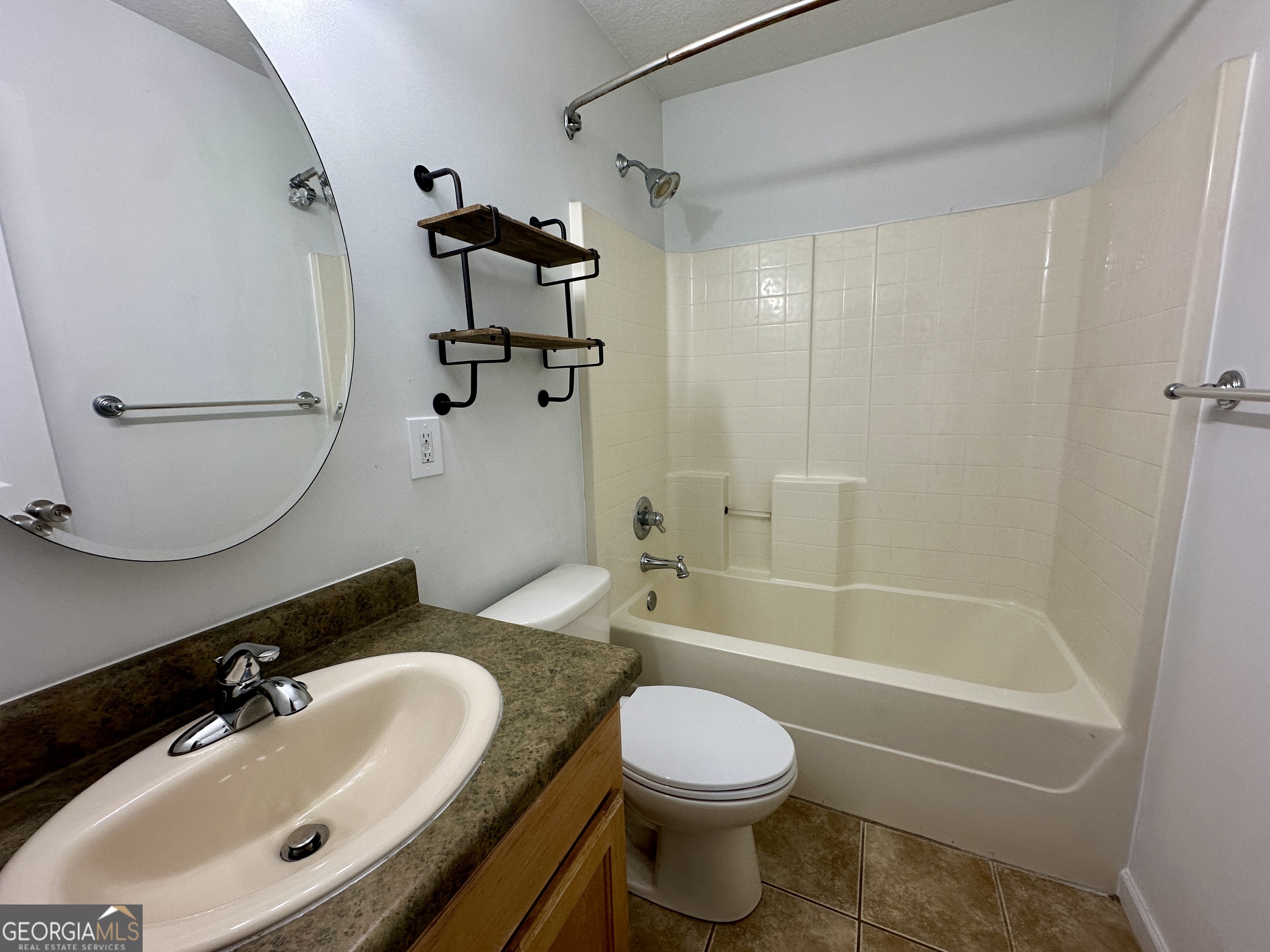 122 Forest Avenue Commerce, GA 30529 - Photo 7 of 17 a bathroom with a sink a toilet and shower