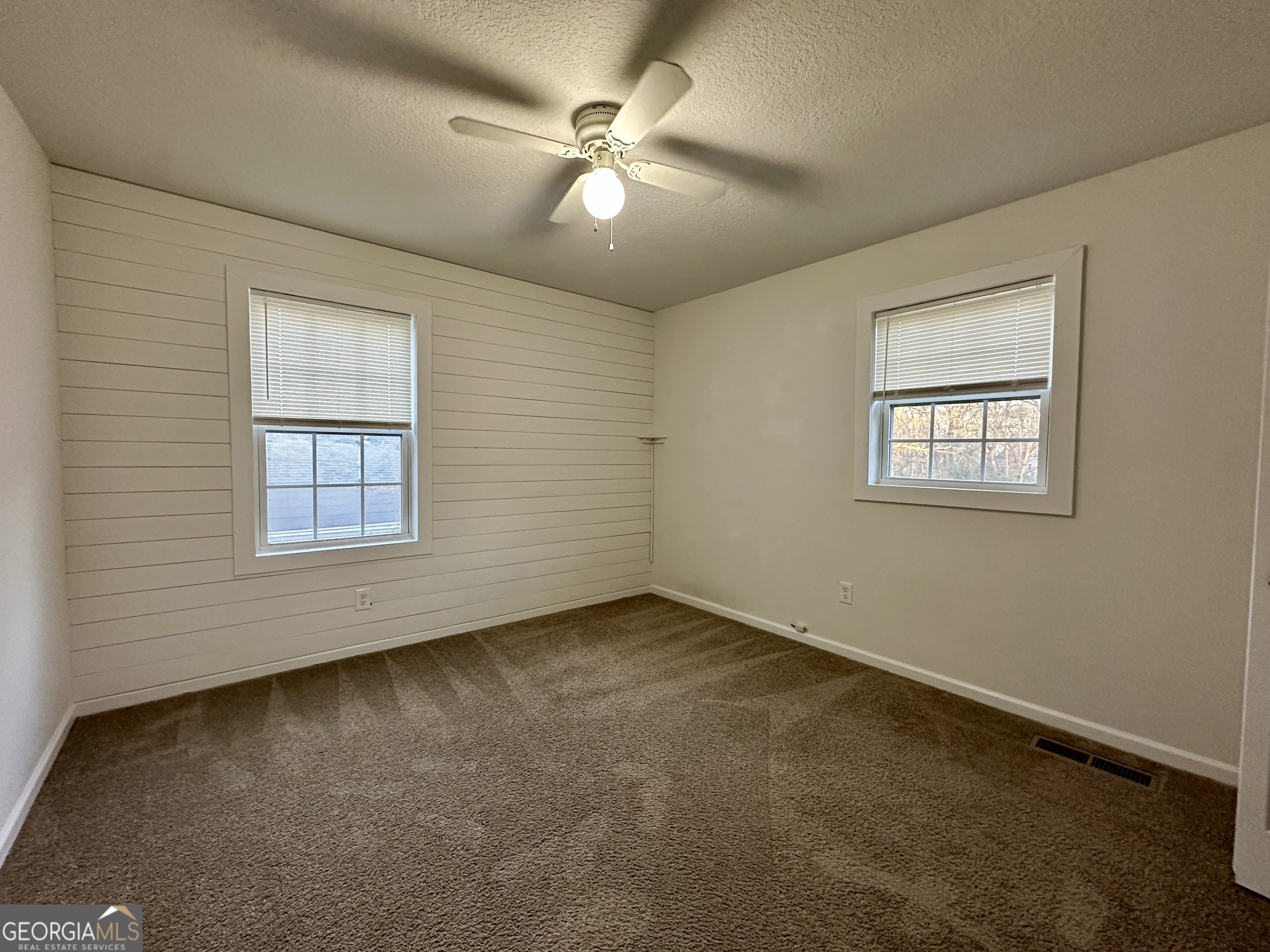 122 Forest Avenue Commerce, GA 30529 - Photo 8 of 17 an empty room with a window and a ceiling fan