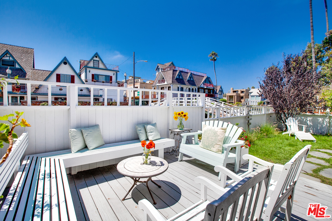 a view of a patio with couches table and chairs and potted plants