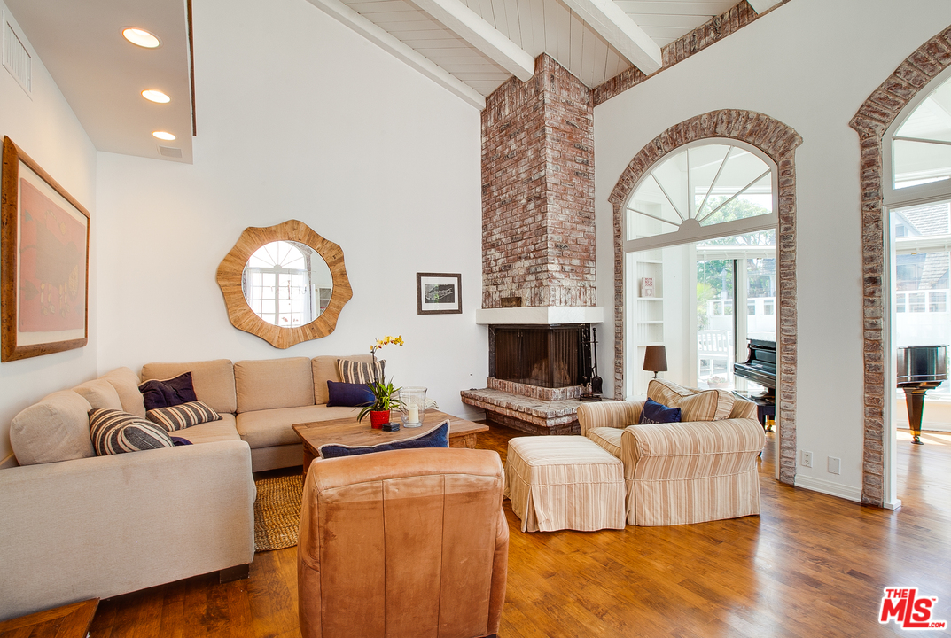 2327 Eastern Court Venice, CA 90291 - Photo 12 of 44 a living room with fireplace furniture and a large window