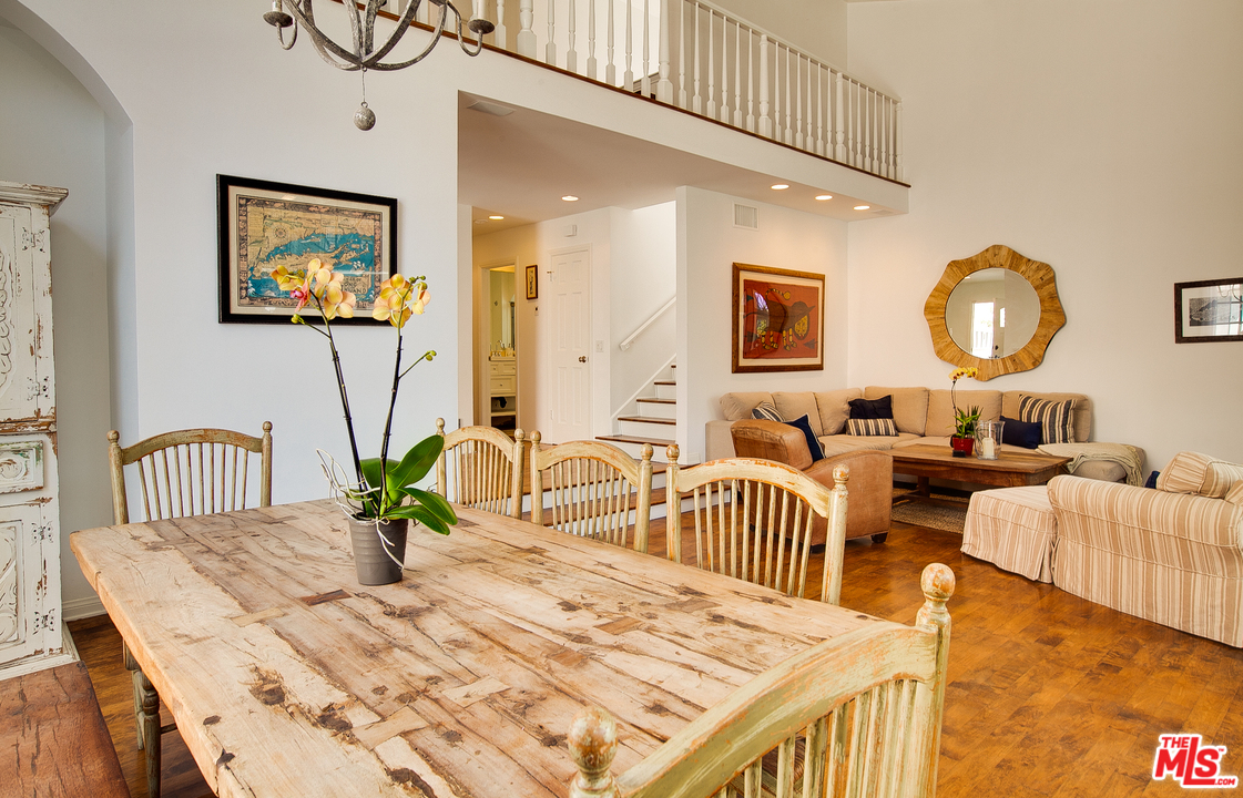 2327 Eastern Court Venice, CA 90291 - Photo 14 of 44 a living room with furniture a chandelier and a wooden floor