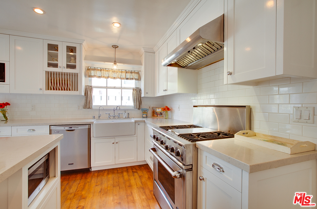 2327 Eastern Court Venice, CA 90291 - Photo 22 of 44 a kitchen with a sink stove top oven and cabinets