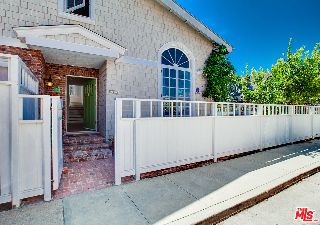 2327 Eastern Court Venice, CA 90291 - Photo 38 of 44 a view of a white house with large windows and a small yard