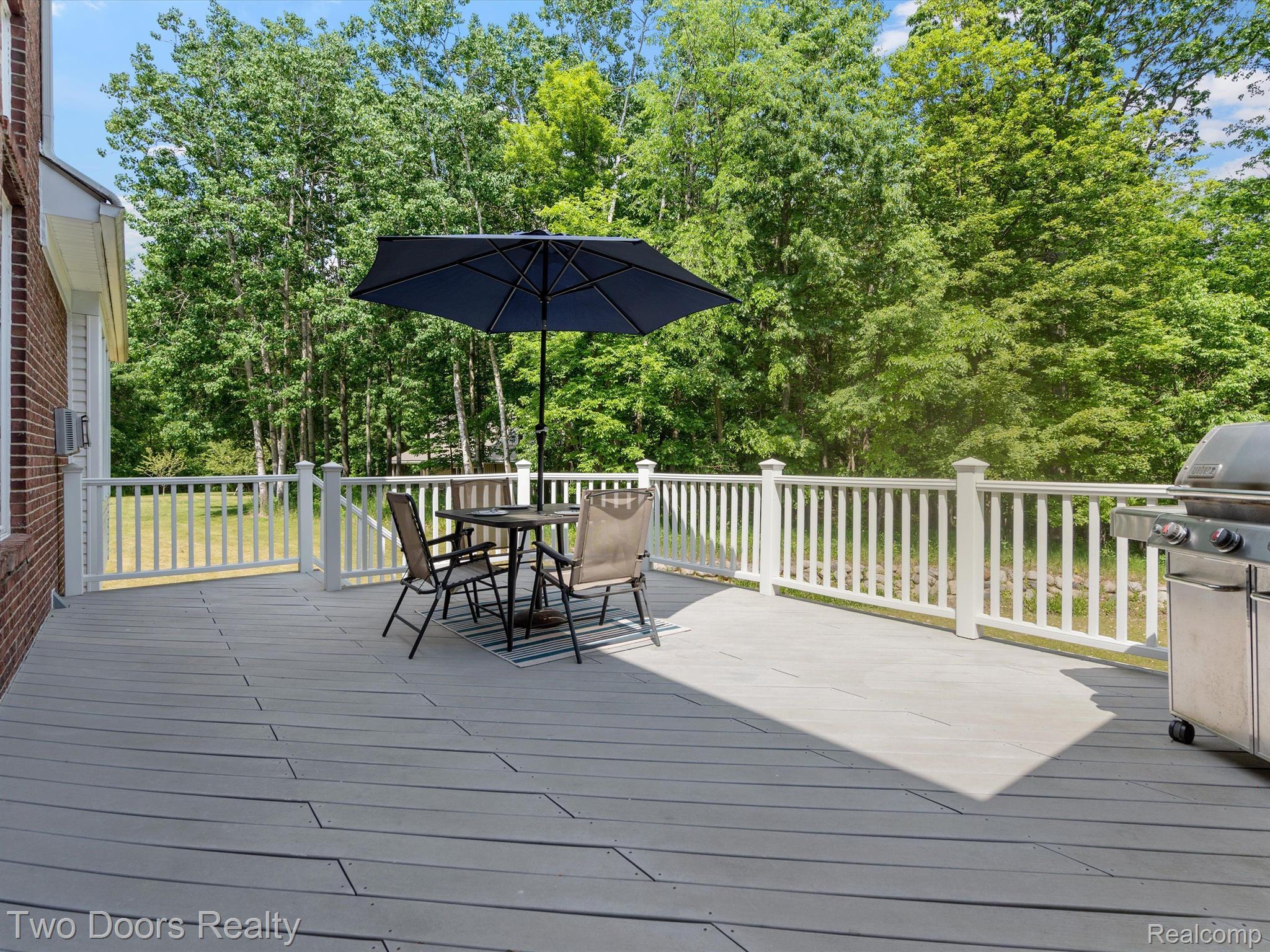 4060 Lake George Road Leonard, MI 48367 - Photo 17 of 86 Large deck leads to walk out basement patio