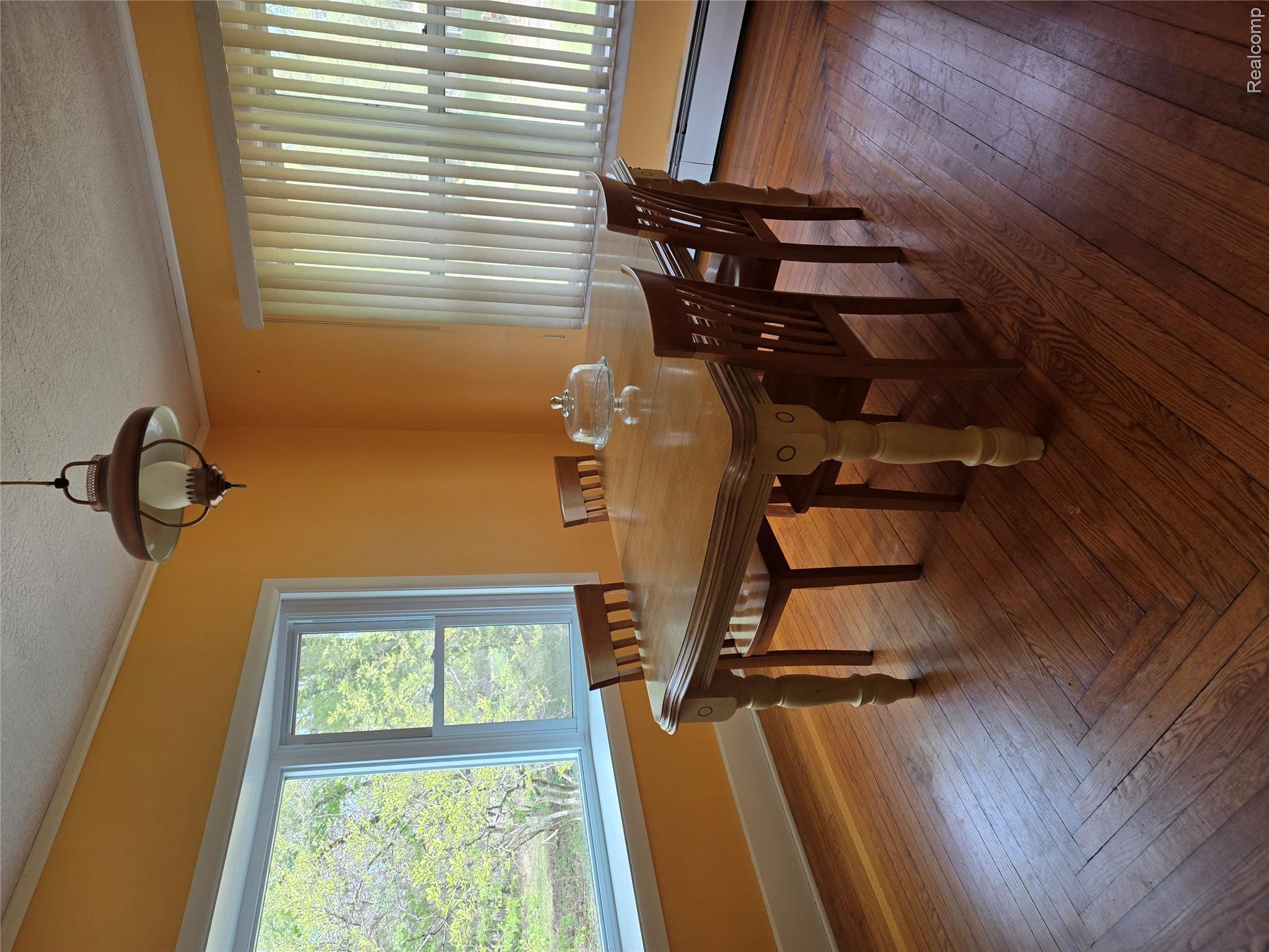 403 East Road Holly, MI 48442 - Photo 6 of 22 Dining space featuring dark wood-type flooring, baseboard heating, crown molding, and a textured ceiling