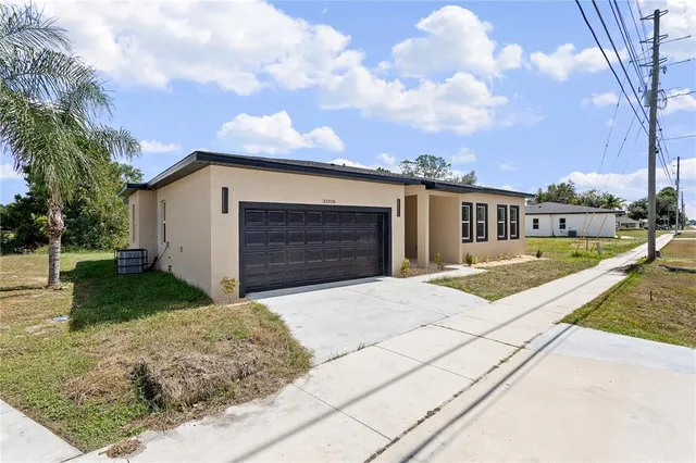 a front view of a house with a yard and garage