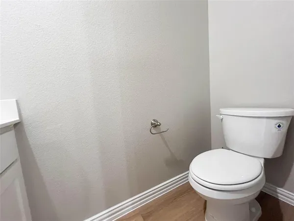 a white toilet sitting next to a small window