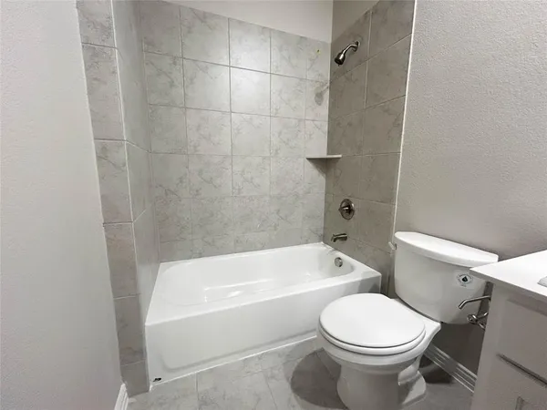 a bathroom with a toilet and a bath tub