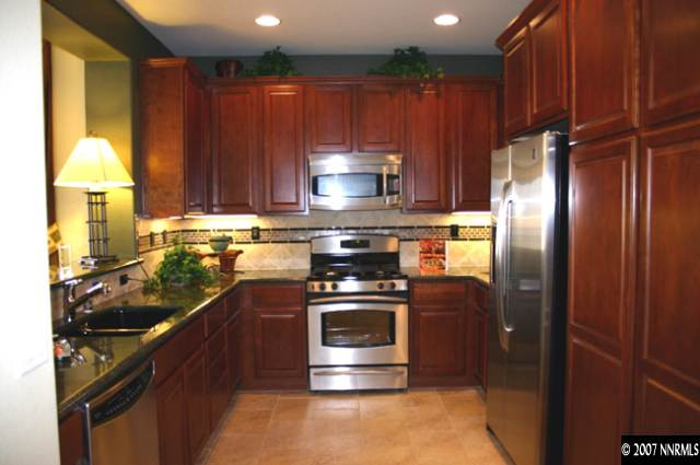 530 Seattle Slew Court Reno, NV 89521 - Photo 4 of 9 a kitchen with stainless steel appliances granite countertop a stove a refrigerator and a sink