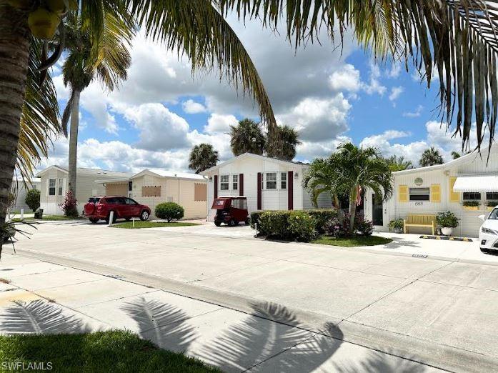 554 Cattleya Refuge, Unit 554 Naples, FL 34114 - Photo 13 of 49 a front view of a house with a yard and a garage