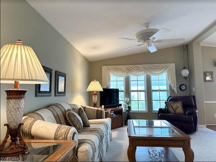 554 Cattleya Refuge, Unit 554 Naples, FL 34114 - Photo 18 of 49 a living room with furniture a chandelier and a large window