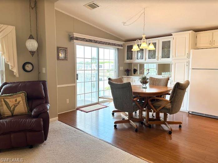 554 Cattleya Refuge, Unit 554 Naples, FL 34114 - Photo 20 of 49 a view of a dining room with furniture and wooden floor