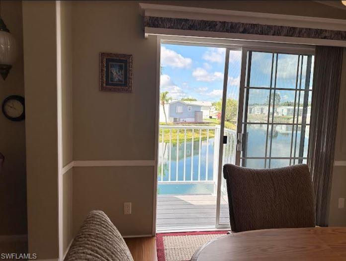 554 Cattleya Refuge, Unit 554 Naples, FL 34114 - Photo 21 of 49 a living room with a large window and a bed