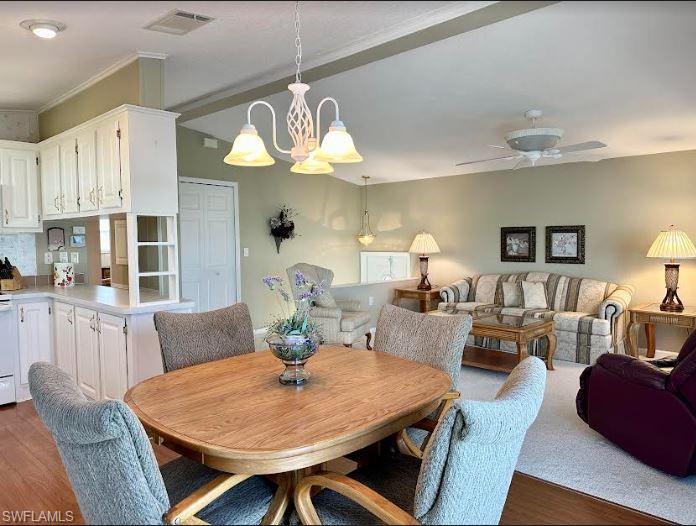 554 Cattleya Refuge, Unit 554 Naples, FL 34114 - Photo 23 of 49 a view of a dining room with furniture