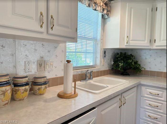 554 Cattleya Refuge, Unit 554 Naples, FL 34114 - Photo 27 of 49 a kitchen with a sink and a white cabinets