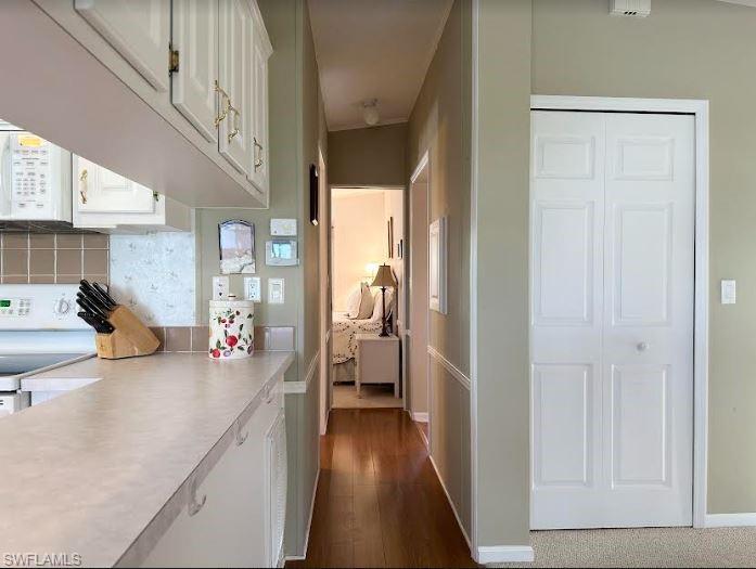 554 Cattleya Refuge, Unit 554 Naples, FL 34114 - Photo 28 of 49 a view of a hallway view with wooden floor and furniture
