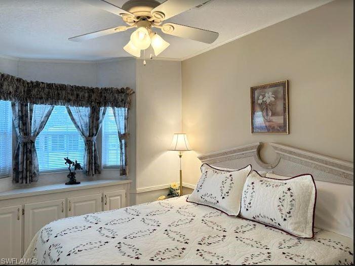 554 Cattleya Refuge, Unit 554 Naples, FL 34114 - Photo 35 of 49 a bedroom with a large bed and a large mirror