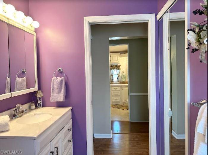 554 Cattleya Refuge, Unit 554 Naples, FL 34114 - Photo 40 of 49 a bathroom with a granite countertop sink and a mirror