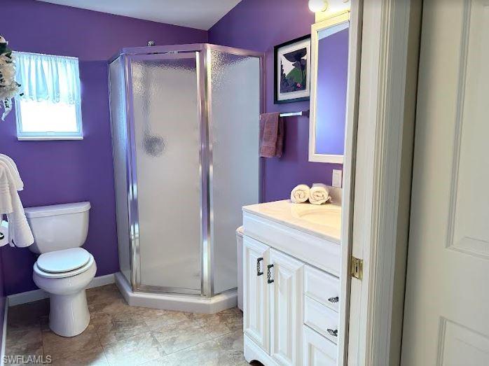 554 Cattleya Refuge, Unit 554 Naples, FL 34114 - Photo 41 of 49 a bathroom with a granite countertop toilet sink and mirror