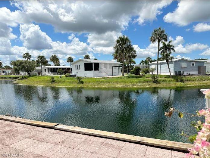 554 Cattleya Refuge, Unit 554 Naples, FL 34114 - Photo 7 of 49 a view of a lake with a house