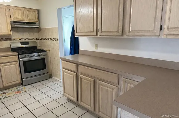 a kitchen with stainless steel appliances granite countertop a sink and a stove