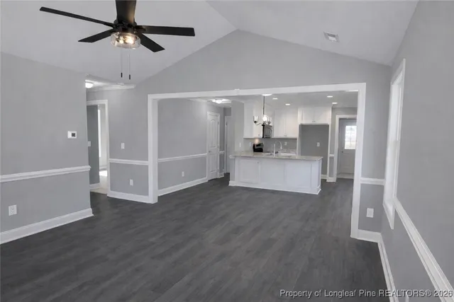 a view of a kitchen with wooden floor and a sink