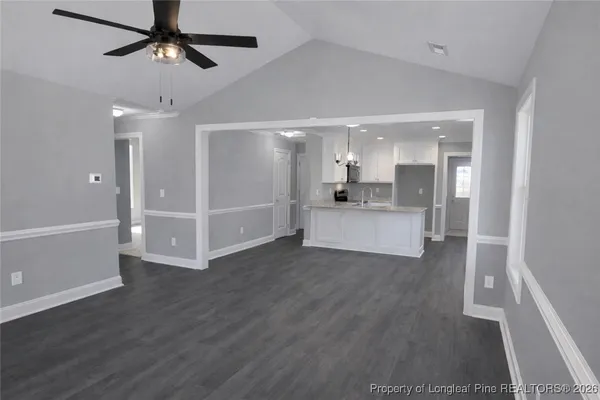 a view of a kitchen with wooden floor and a sink