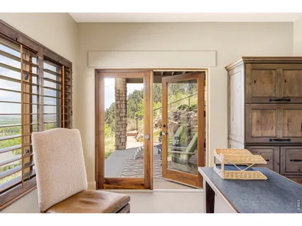 a living room with furniture and large windows