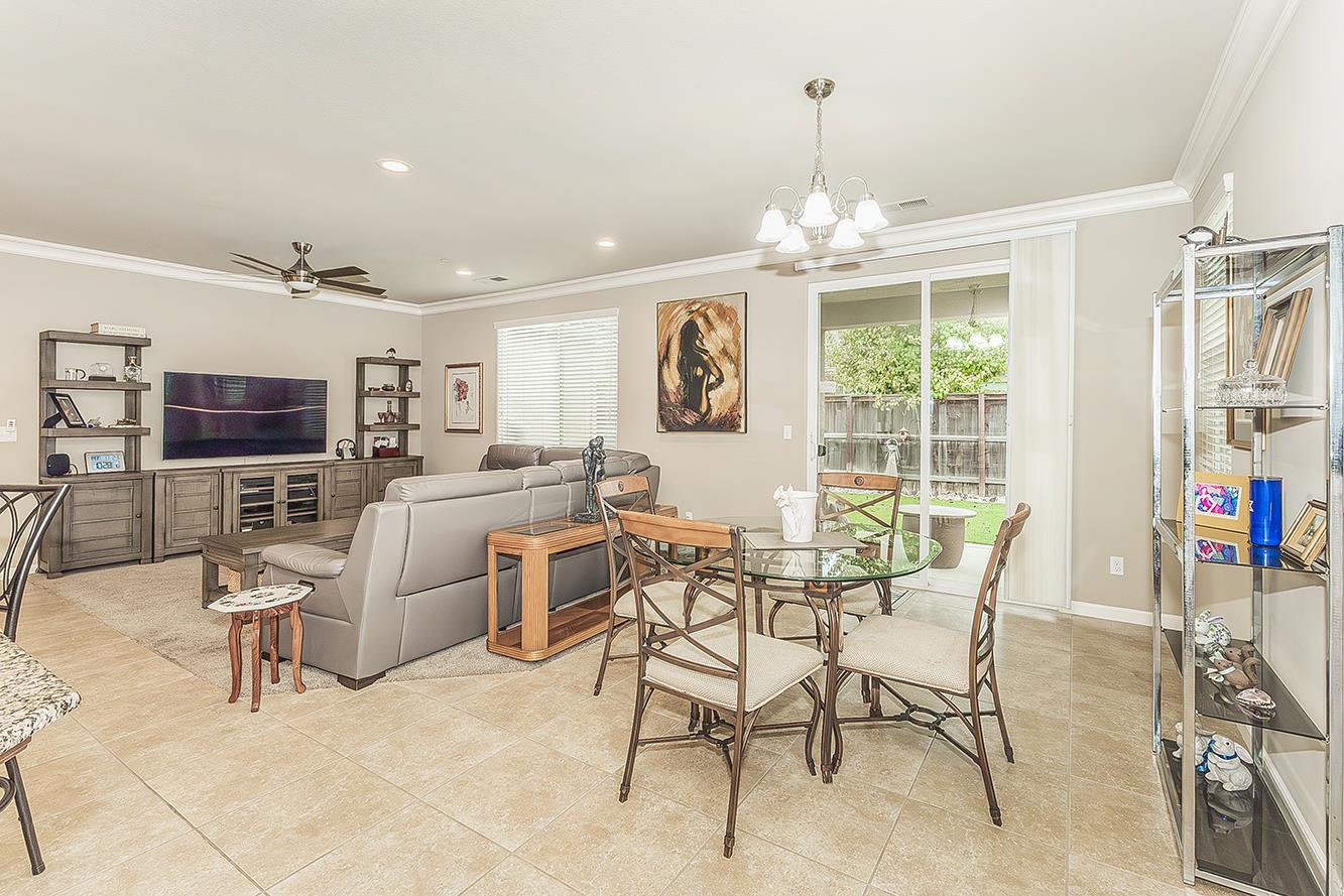 7133 North Generation Drive Fresno, CA 93711 - Photo 12 of 38 a view of a livingroom with furniture and a chandelier