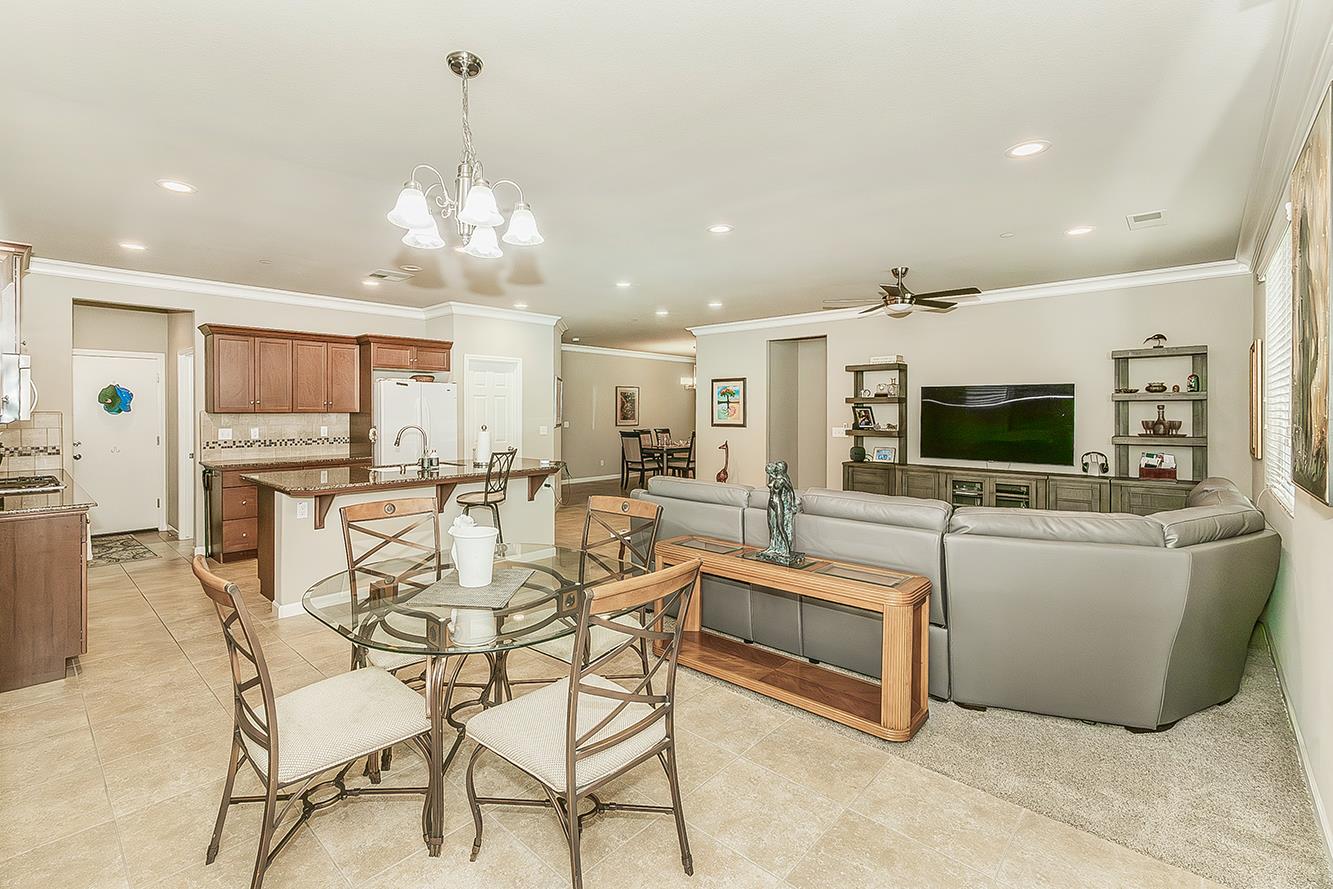 7133 North Generation Drive Fresno, CA 93711 - Photo 13 of 38 a view of a dining room with furniture window and wooden floor