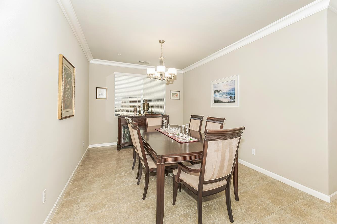 7133 North Generation Drive Fresno, CA 93711 - Photo 15 of 38 a view of a dining room with furniture and chandelier