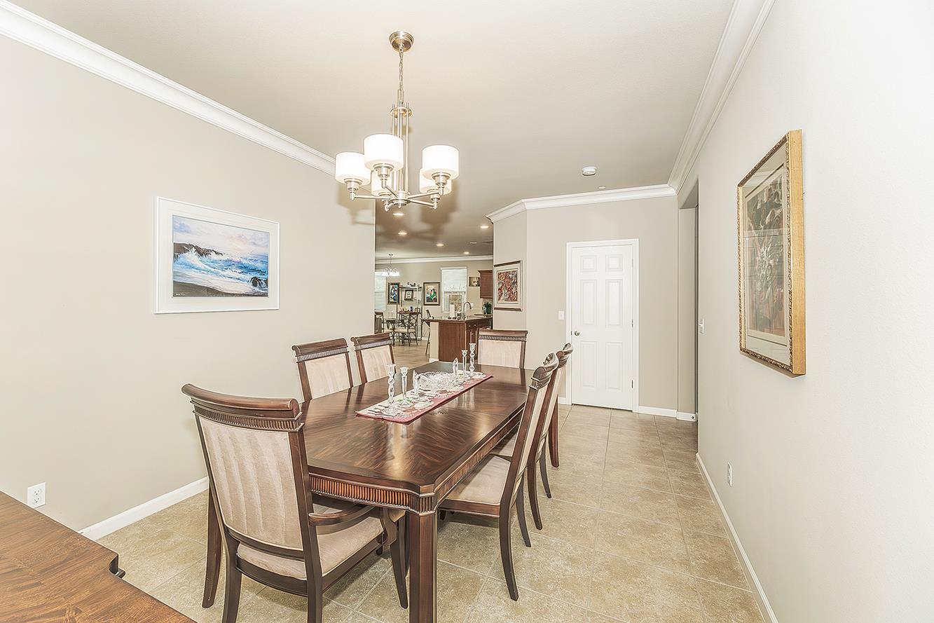 7133 North Generation Drive Fresno, CA 93711 - Photo 16 of 38 a view of a dining room with furniture and chandelier