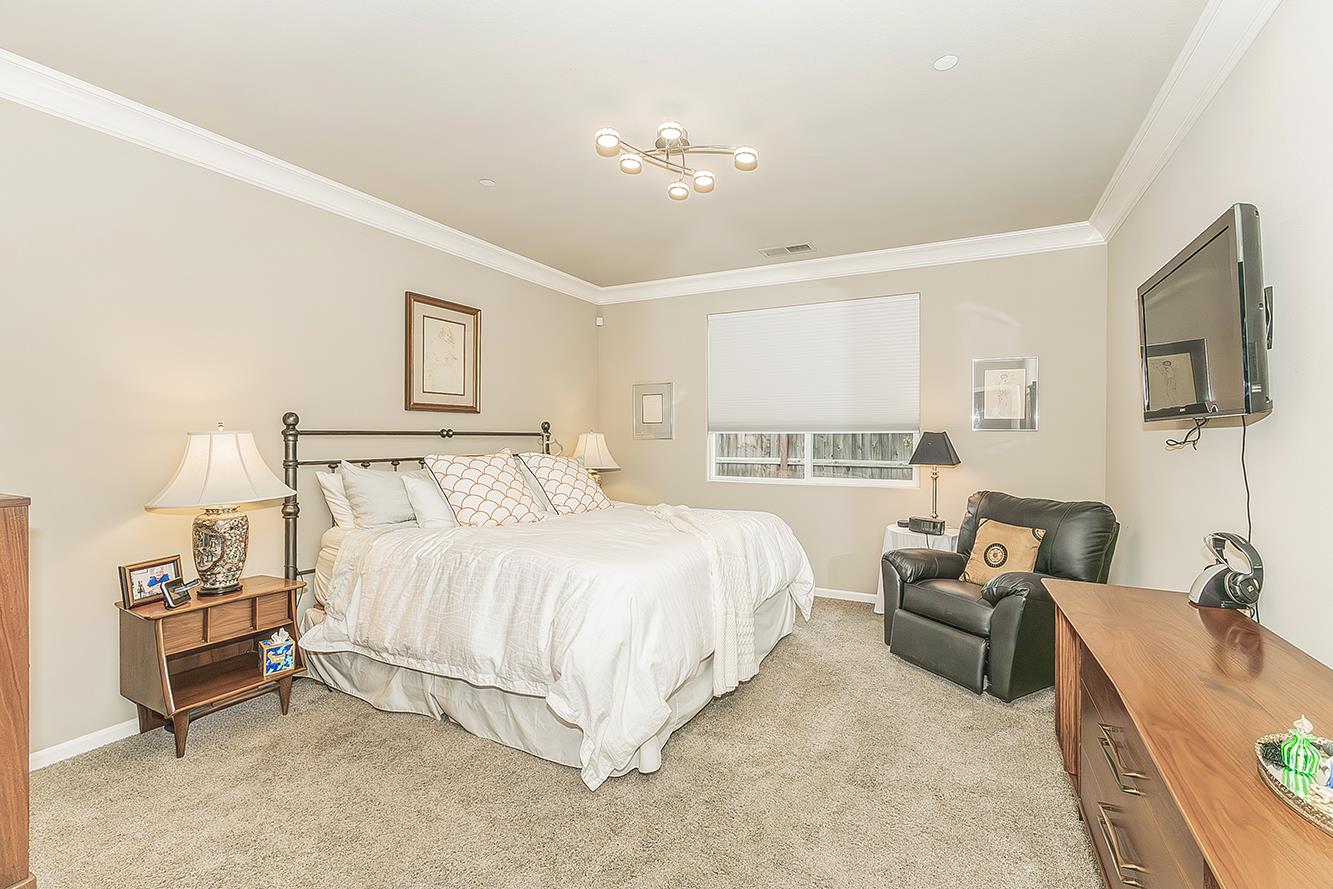 7133 North Generation Drive Fresno, CA 93711 - Photo 17 of 38 a spacious bedroom with a bed and furniture