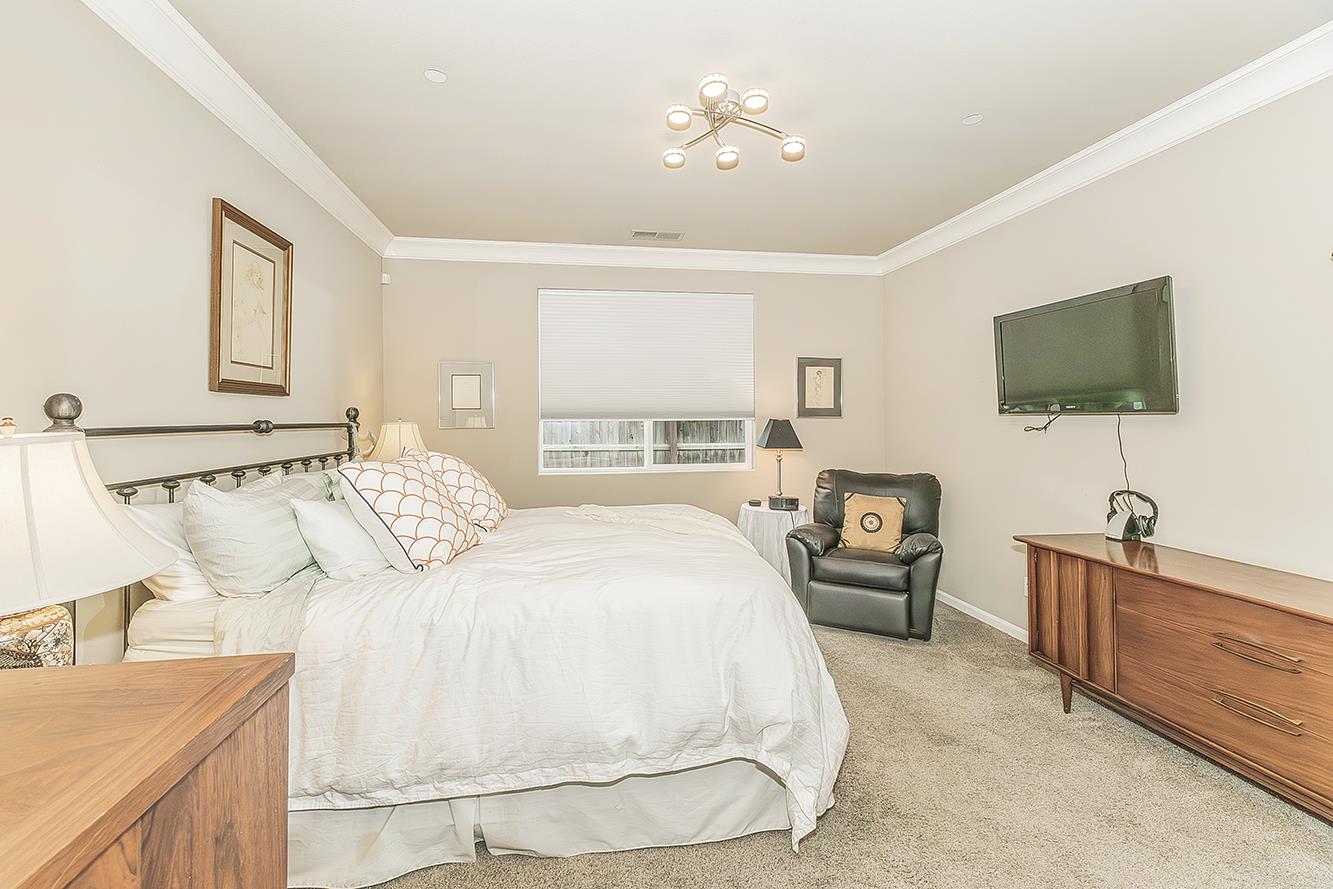 7133 North Generation Drive Fresno, CA 93711 - Photo 19 of 38 a bedroom with a bed and a flat screen tv