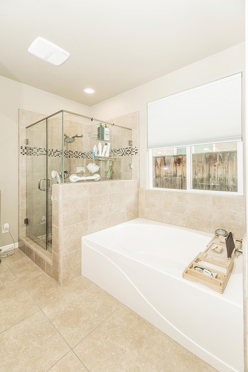7133 North Generation Drive Fresno, CA 93711 - Photo 23 of 38 a bathroom with a tub sink and shower
