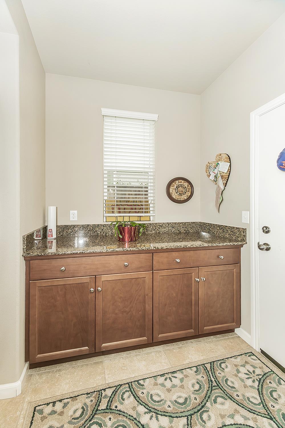 7133 North Generation Drive Fresno, CA 93711 - Photo 31 of 38 a spacious bathroom with a granite countertop sink and a mirror