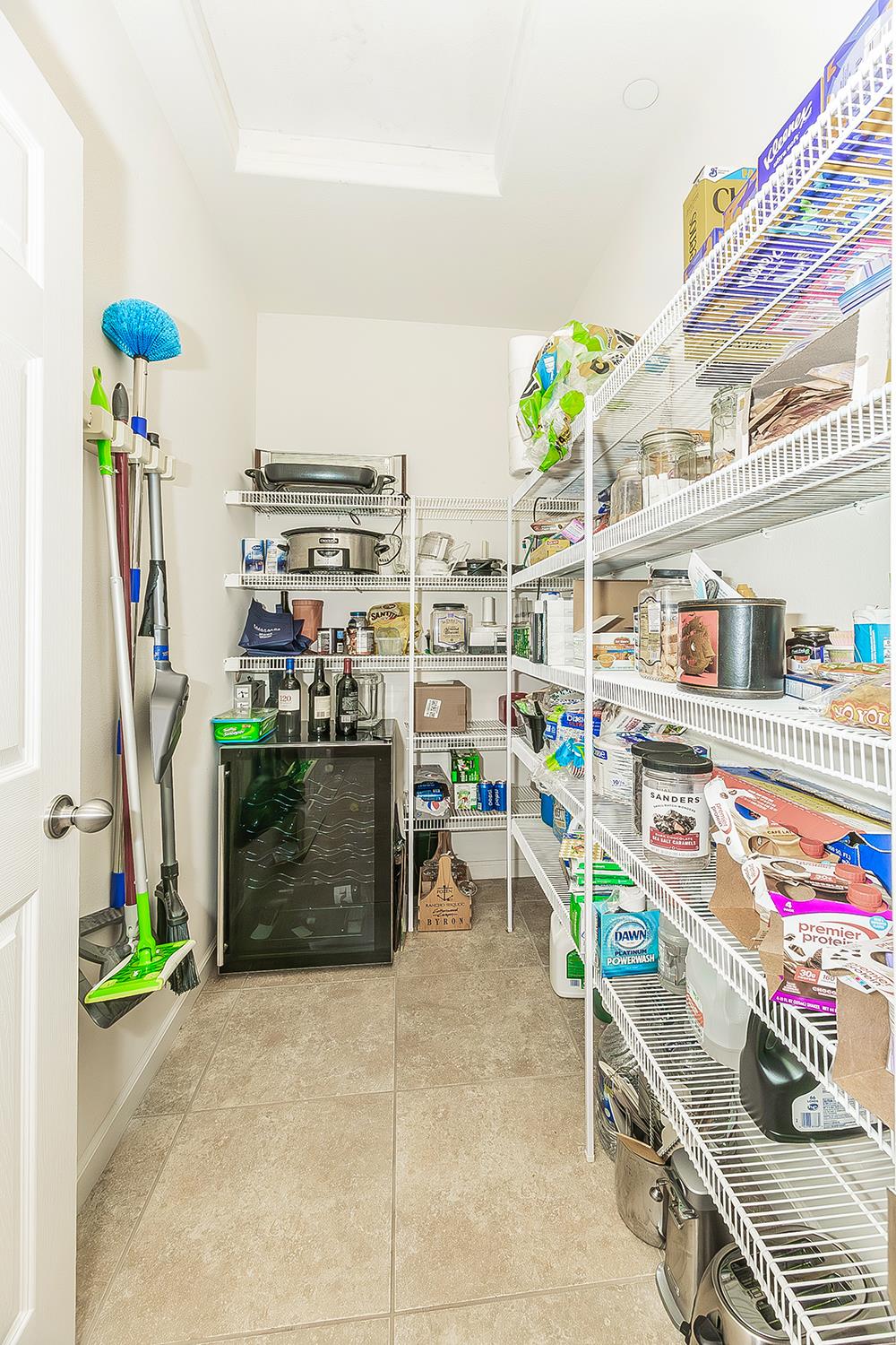 7133 North Generation Drive Fresno, CA 93711 - Photo 34 of 38 a utility room with fridge and outdoor view