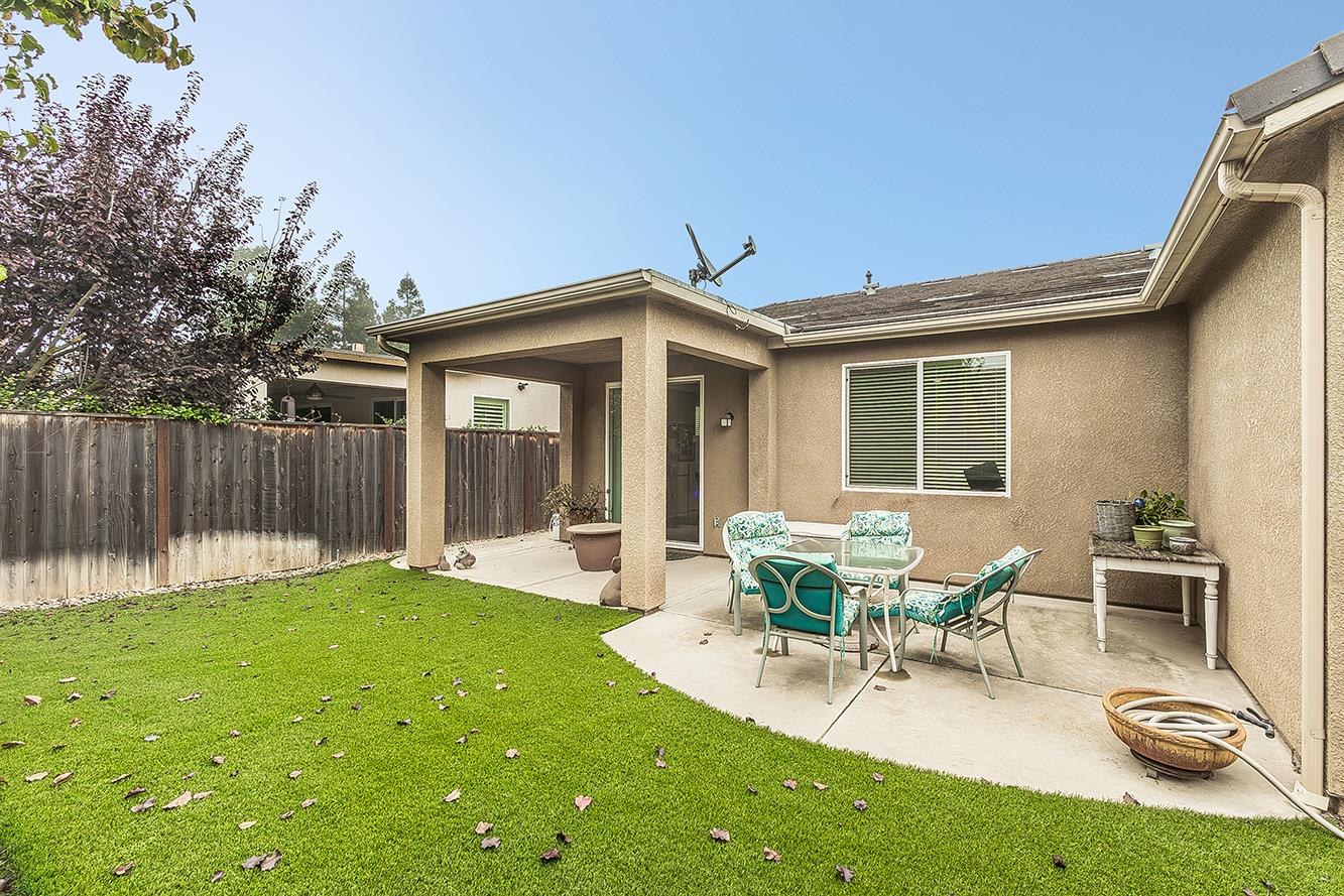 7133 North Generation Drive Fresno, CA 93711 - Photo 36 of 38 a view of a house with backyard sitting area and garden