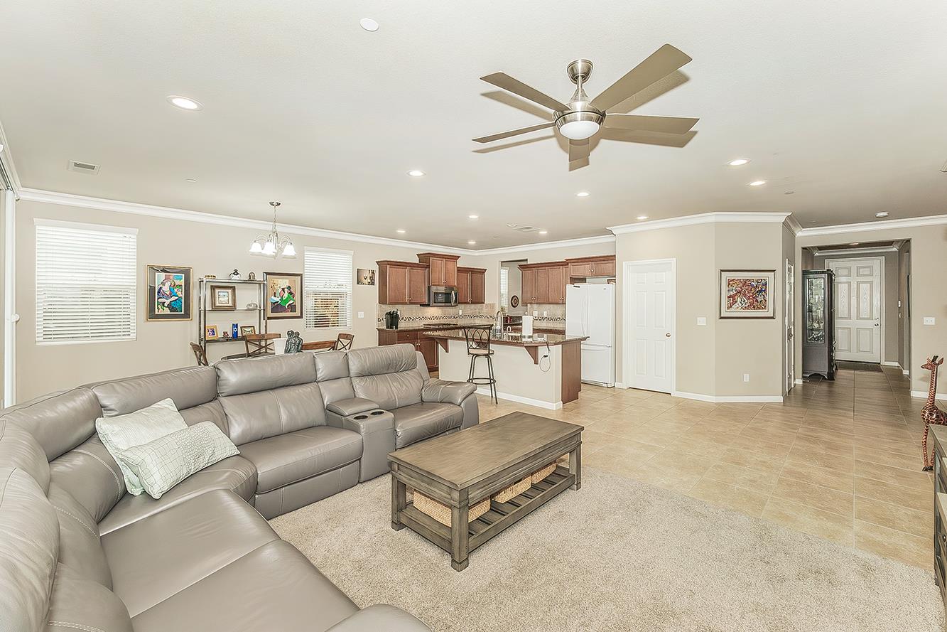 7133 North Generation Drive Fresno, CA 93711 - Photo 7 of 38 a living room with furniture kitchen view and a chandelier