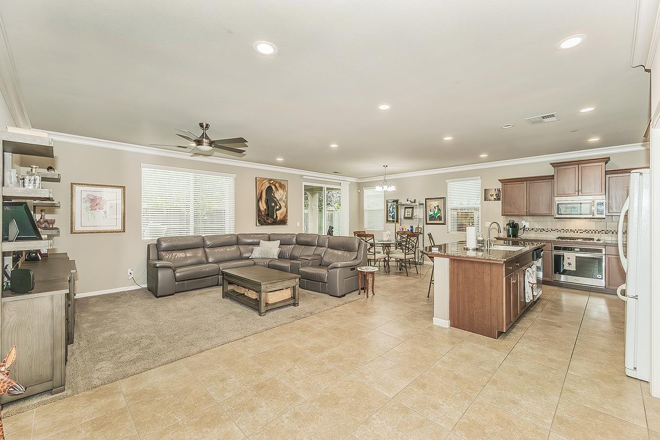 7133 North Generation Drive Fresno, CA 93711 - Photo 8 of 38 a living room with lots of furniture and white walls