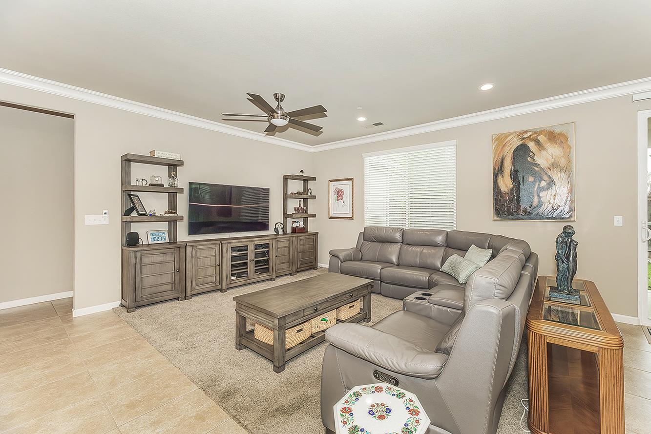 7133 North Generation Drive Fresno, CA 93711 - Photo 10 of 38 a living room with furniture and a flat screen tv