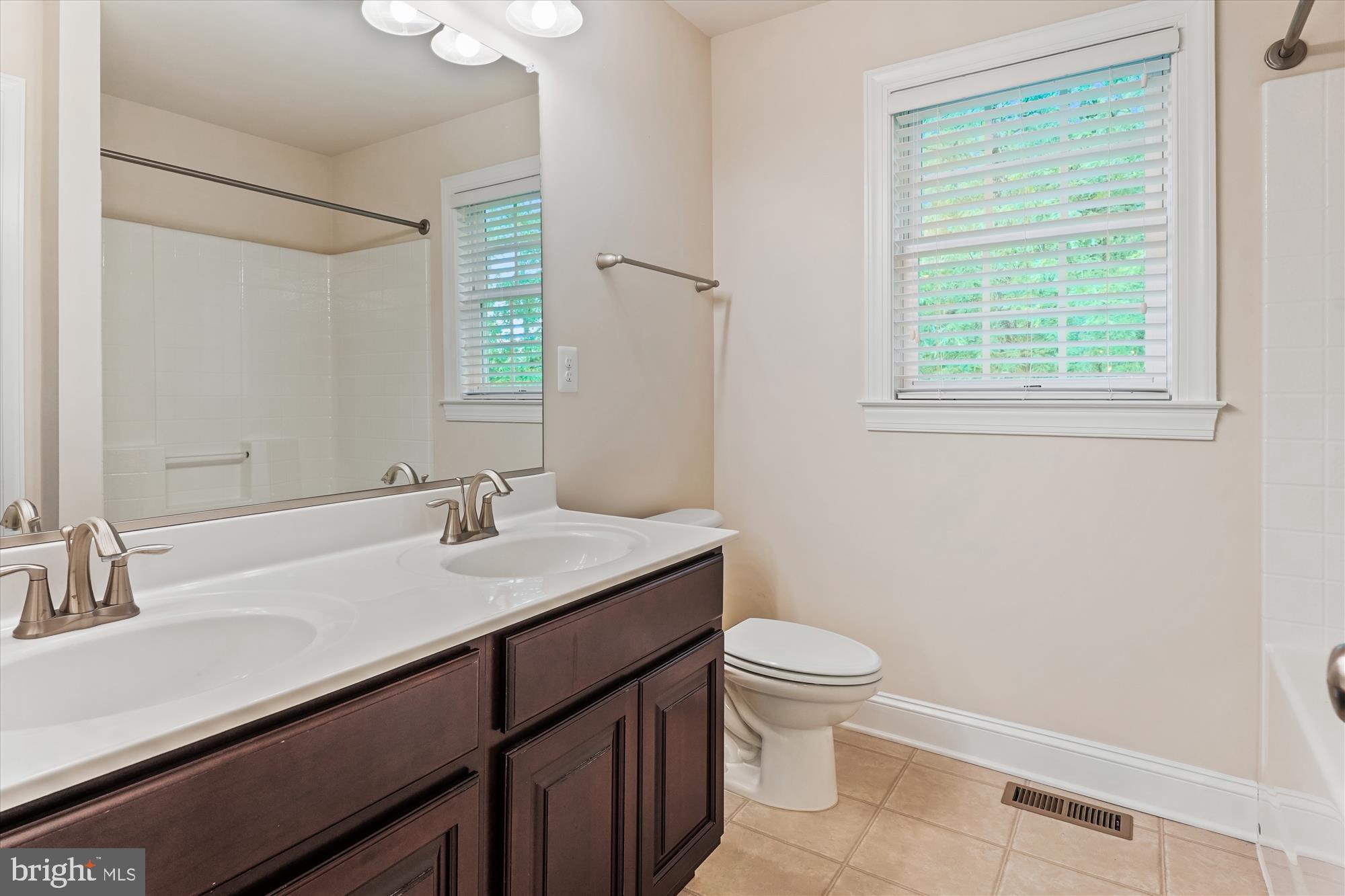 70 Ruby Glen Lane Fredericksburg, VA 22405 - Photo 41 of 72 a bathroom with a sink a toilet a mirror and a window