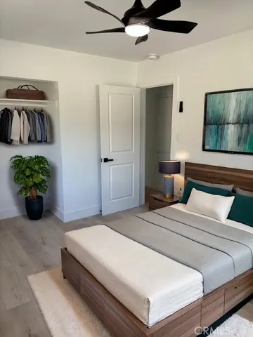 a bedroom with a bed and a potted plant