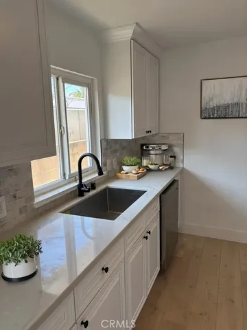 a kitchen with a sink and cabinets